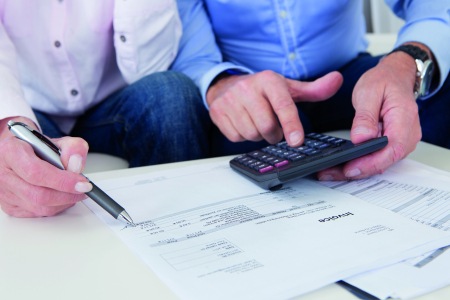 bills and a calculator lie on a table