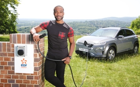 Ore Oduba charging an electric car 