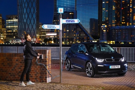 person charging electric vehicle