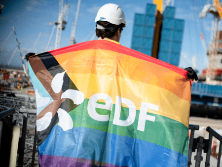 employee on site holding a pride progress flag