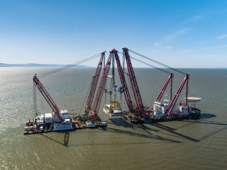 The six giant heads were lowered onto the seabed of the Bristol Channel - which has the 2nd highest tidal range in the world! They weigh 5,000 tonnes each and were installed using floating cranes (the size of football pitches).