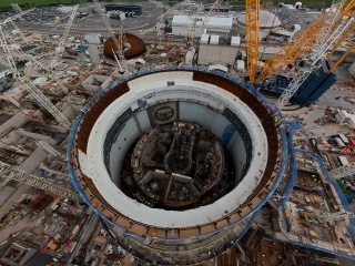The site approaching the next major engineering feat - when Big Carl, the world's largest land-based crane, will lift the 245-tonne steel dome to close the first reactor building.
