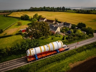 Steam Generator passing houses in a Somerset village