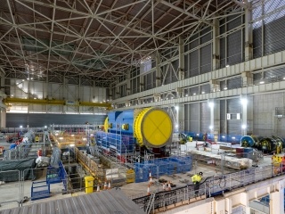Inside Unit 1’s Turbine Hall. Pictured centre is the 450 tonne Generator Stator. The stator will take the power from the steam produced in the Reactor – via the Steam Turbine – to make electricity. 