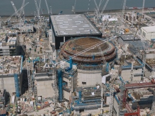 Aerial image showing Unit 1 reactor with colleagues visible on the Dome completing its concrete containment.