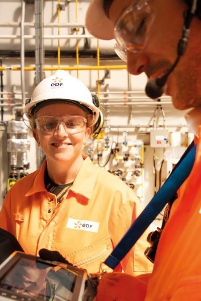 Nuclear engineers on site at nuclear power station using tablet