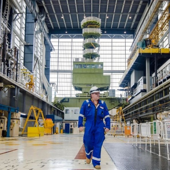 Nuclear engineer walks through the turbine hall