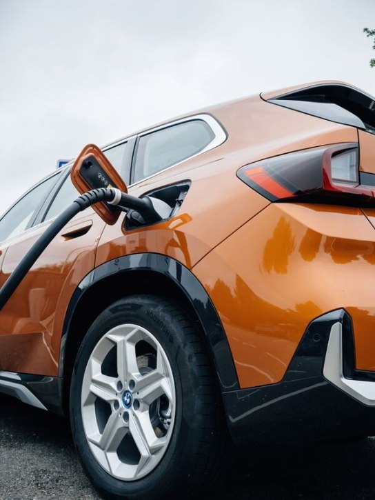 Orange BMW electric car being charged