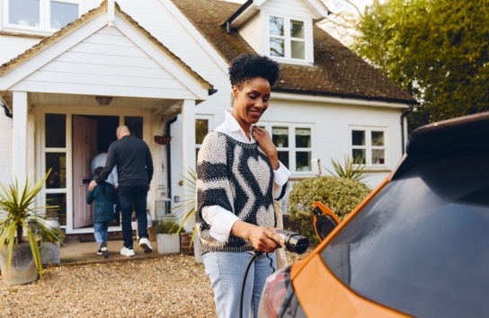 A woman charging her EV