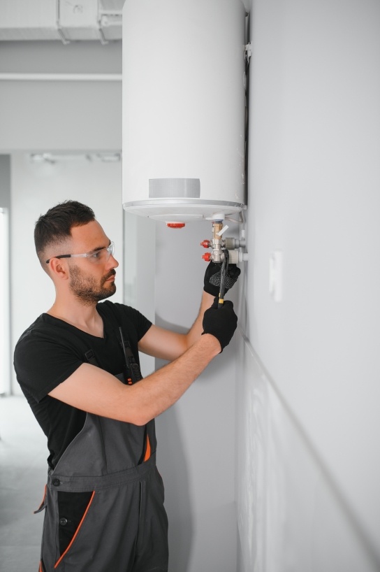 A boiler engineer servicing a boiler 