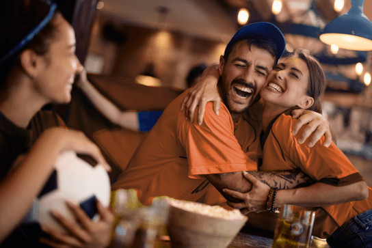 Friends celebrating football goal
