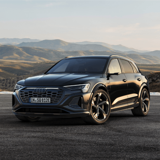 Audi Q8 e-tron in black driving down road