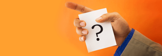 Hand holding card with question mark on it