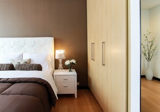A smart-looking bedroom with bedside light on