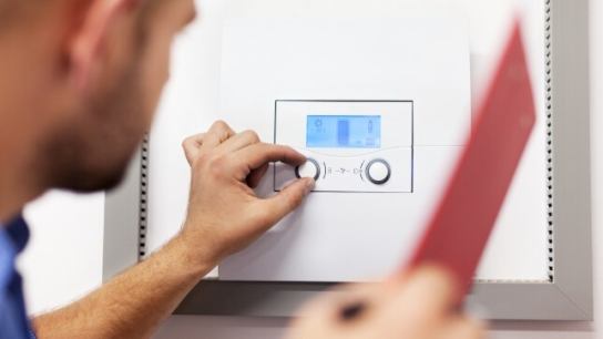 boiler being serviced and inspected by an engineer