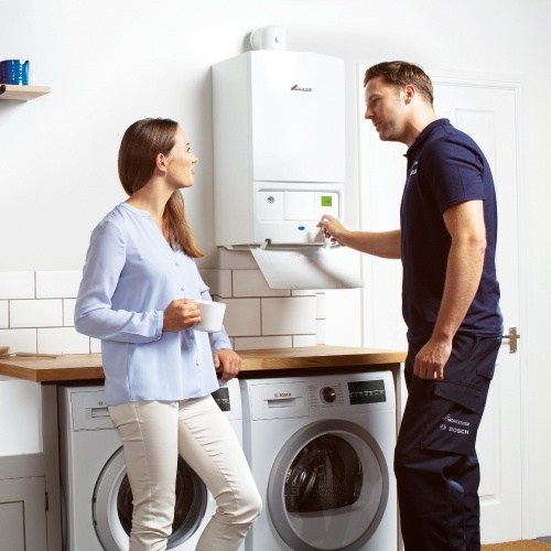 couple standing next to boiler