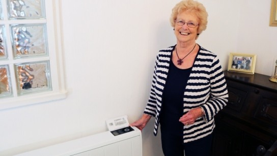 Dimplex Quantum storage heater installed in home with happy elderly lady