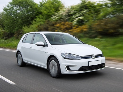 white e-golf driving on road