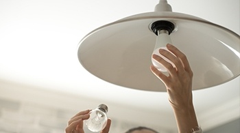 A lightbulb being changed in an overhead light