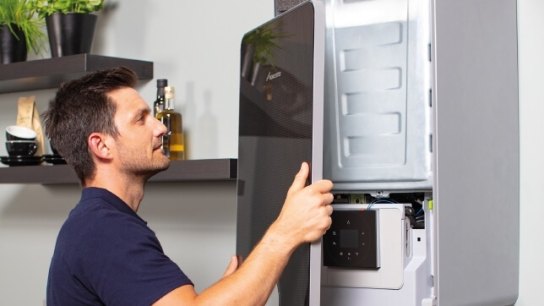 engineer replacing a boiler with a new one