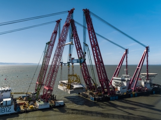The second 5,000-tonne intake head as it begins to be lowered into the Bristol Channel. The moment represents the latest spectacular engineering achievement at Hinkley Point C.