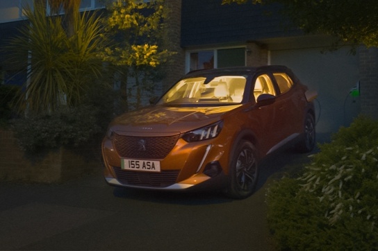 peugeot e2008 in orange at night on a driveway