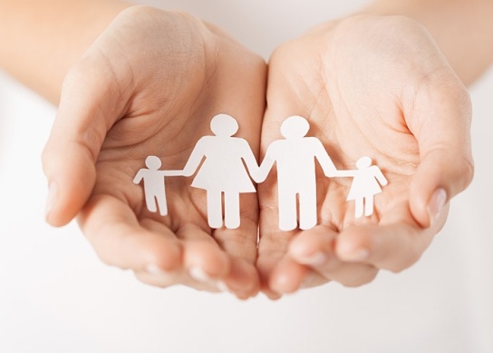 Supporting Our Customers - Hands holding paper cut-out family