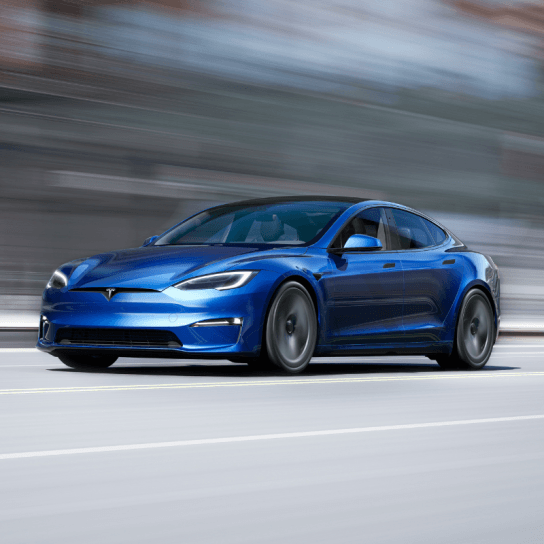 Tesla Model S in blue driving down road
